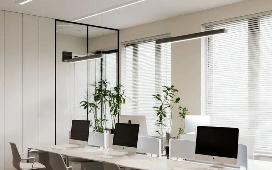 Light-filled open office table with contemporary laptops and glass accents